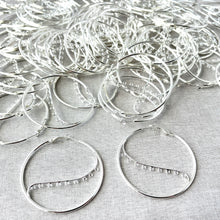 Load image into Gallery viewer, Silver Plated Steel 50mm Round Hoop Earrings - 9 Closed Loops - Hinged - 50 pairs arranged on a light fabric background, showcasing detailed loop design and secure hinged clasps.