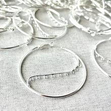 Load image into Gallery viewer, Close-up of silver hoop earrings featuring delicate 9 closed loops on a hinged design, representing Silver Plated Steel 50mm Round Hoop Earrings - 9 Closed Loops - Hinged - 50 pairs.