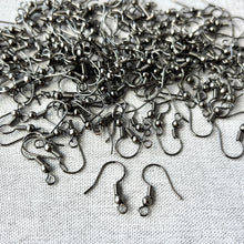 Load image into Gallery viewer, Gunmetal colored fish hook style earring findings laid out on a fabric surface, showing a large quantity and close-up details of the hooks with coils and small balls, illustrating Gunmetal Fish Hook Earwires - Pack of 150 Earwires - 75 Pairs.