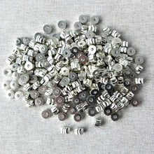 Load image into Gallery viewer, Silver Diamond Cut Swirl Drum Beads - 6x4mm - Pkg of 224 - Spacer Beads Metal Beads arranged on a light fabric background, showing their shiny silver swirl design.