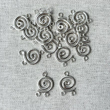 Load image into Gallery viewer, Circle Spiral Chandelier Drop - 10mm Round 2 Loops - Sterling Silver - Package of 48 shown on textured fabric background, highlighting their detailed spiral design for jewelry making.