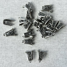Load image into Gallery viewer, Sterling Silver Open Filigree Bail - 13mm x 11mm - Pack of 20 displayed on a fabric background, showing detailed openwork design ideal for jewelry making.