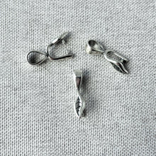 Load image into Gallery viewer, Three silver plated Leaf Prong Bail - Silver Plated - Pack of 3 jewelry findings displayed on a textured gray fabric background.
