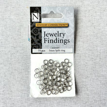 Load image into Gallery viewer, 5mm Rhodium Split Rings - Pack of 75 silver-colored jewelry findings used as connectors or jump rings for assembling necklaces, charms, and other craft supplies.