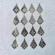 Load image into Gallery viewer, Drop, Lazer Lace™, silver-finished brass, 29x22mm kite with "Good luck" symbol with 5 loops - Sold per pkg of 16, arranged on a textured light gray fabric background.
