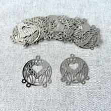 Load image into Gallery viewer, Drop, Lazer Lace™, silver-finished brass, 22mm round with heart, 4 loops. Sold per pkg of 20, showing delicate round charms with detailed heart cutouts and multiple loops for jewelry making.