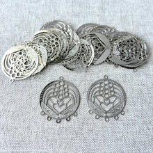 Load image into Gallery viewer, Drop, Lazer Lace™, silver-plated brass, 28x24mm round with fancy heart, 5+1 loops. Sold per pkg of 20, showing intricate filigree metal components for jewelry making.