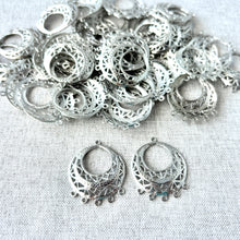 Load image into Gallery viewer, Filigree Circle - Domed Chandelier - White Plated over Brass - Silver - 30mmx24mm - Pack of 34 intricate silver chandelier-style filigree components with a domed design on a neutral fabric background.