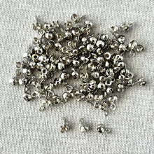 Load image into Gallery viewer, Small shiny bead tip clamshell crimp ends made of nickel plated brass scattered on a textured fabric surface, Bead Tip Clamshell Crimp Ends - Findings - Nickel Plated Brass - bead tip crimp beads with clamshells - Pack of 100.