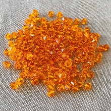Load image into Gallery viewer, 4mm Sun Swarovski Bicone Crystals - Sun Orange - Pack of 174 Crystals - The Attic Exchange