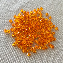Load image into Gallery viewer, 4mm Sun Swarovski Bicone Crystals - Sun Orange - Pack of 174 Crystals - The Attic Exchange