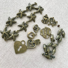 Load image into Gallery viewer, Oxidized Gold Charms - Starfish Hearts Spacers - Mixed Lot - Package of 35 Pieces - The Attic Exchange