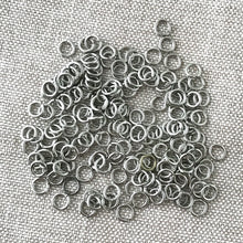 Load image into Gallery viewer, 4mm Rhodium Silver Jump Rings - Jumprings - Silver Plated - Pack of 100 - The Attic Exchange